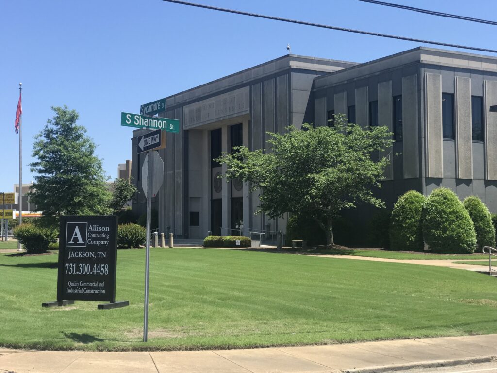 Outside of Jackson City Hall with an "Allison Contracting Company" sign in front of it